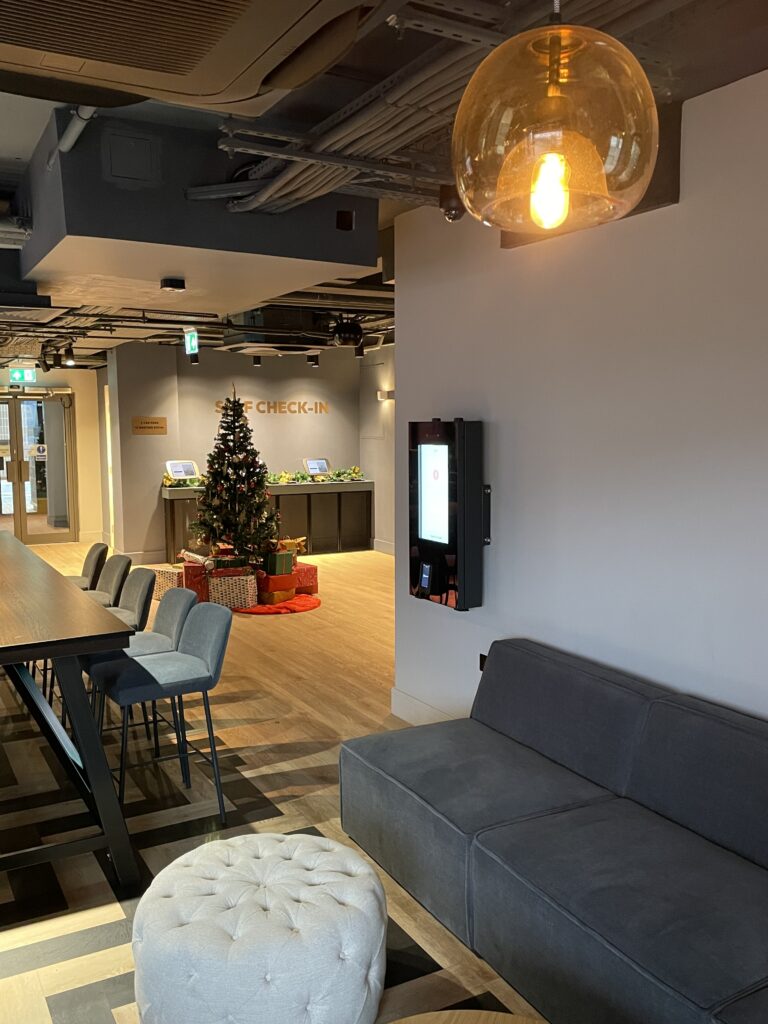 Hotel reception area with EV charging payment kiosk.
