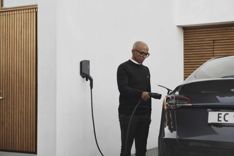 Man charging EV with a home electric car charging point